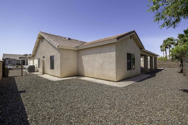14158 E 49th Dr, Yuma, AZ 85367 - view of home's exterior with fence, central air condition unit, stucco siding, and a tiled roof