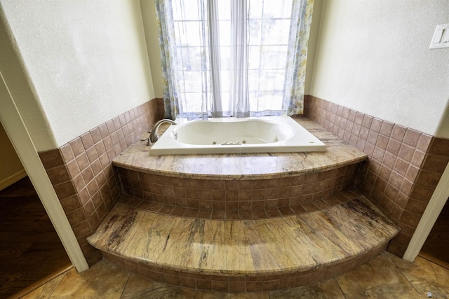 14158 E 49th Dr, Yuma, AZ 85367 - bathroom with a textured wall, a tub with jets, and tile patterned floors