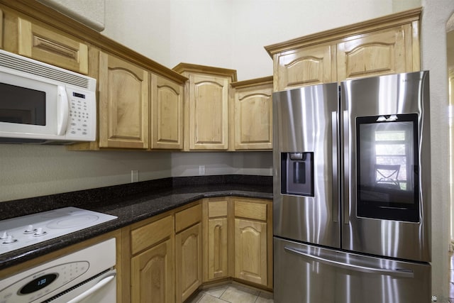 14158 E 49th Dr, Yuma, AZ 85367 - kitchen with white appliances, light tile patterned flooring, and dark stone counters