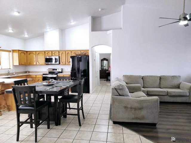 14307 E 49th Ln, Yuma, AZ 85367 - dining room featuring arched walkways, high vaulted ceiling, a ceiling fan, and light tile patterned flooring