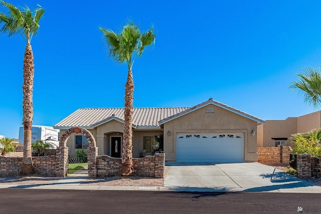 14307 E 49th Ln, Yuma, AZ 85367 - view of front of property with concrete driveway, a garage, a tile roof, and stucco siding