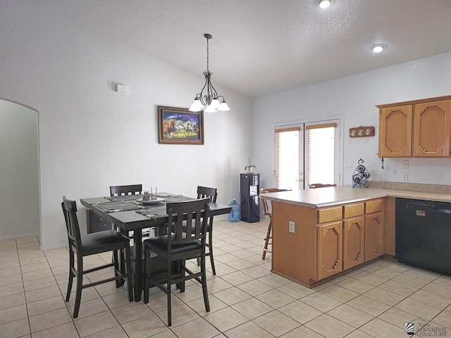 14307 E 49th Ln, Yuma, AZ 85367 - kitchen with light countertops, a chandelier, black dishwasher, a peninsula, and vaulted ceiling