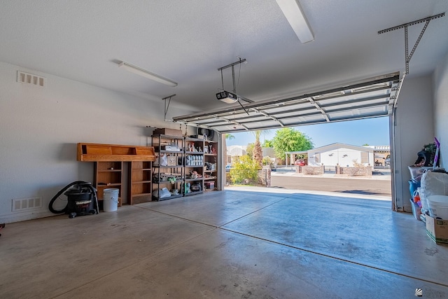 14307 E 49th Ln, Yuma, AZ 85367 - garage featuring visible vents and a garage door opener
