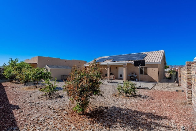 14307 E 49th Ln, Yuma, AZ 85367 - rear view of property with a fenced backyard, a patio area, stucco siding, and solar panels