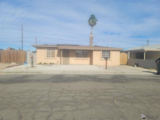 2082 E Ln Mesa St, Yuma, AZ 85365 - view of front of house featuring stucco siding and fence