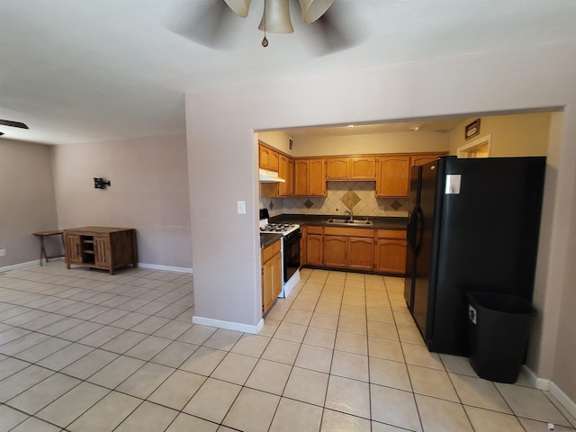2082 E Ln Mesa St, Yuma, AZ 85365 - kitchen featuring ceiling fan, range with gas stovetop, freestanding refrigerator, dark countertops, and light tile patterned floors