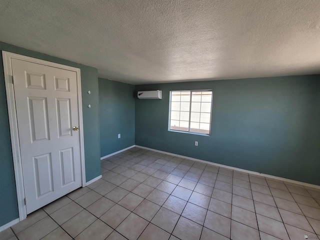 2082 E Ln Mesa St, Yuma, AZ 85365 - spare room featuring a wall mounted AC, a textured ceiling, and light tile patterned flooring