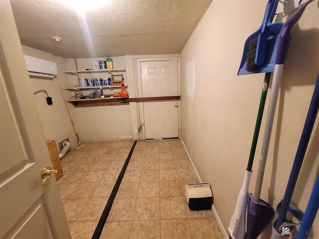 2082 E Ln Mesa St, Yuma, AZ 85365 - laundry area with baseboards, a textured ceiling, a wall unit AC, and light tile patterned flooring