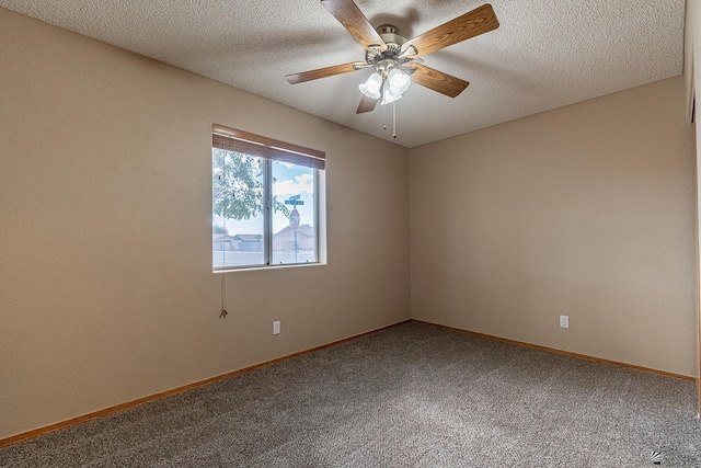 carpeted empty room with a textured ceiling, ceiling fan, and baseboards