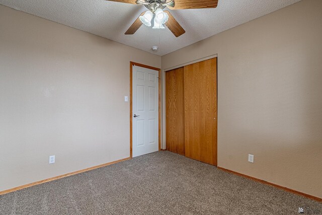 unfurnished bedroom featuring a closet, baseboards, ceiling fan, and carpet flooring