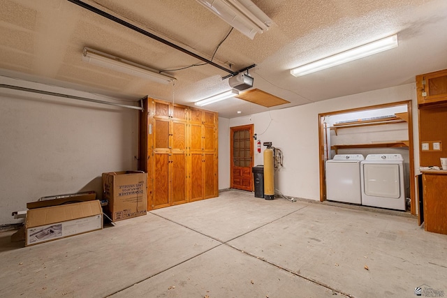 garage featuring a garage door opener and washing machine and clothes dryer