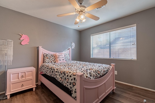 bedroom with dark hardwood / wood-style floors and ceiling fan