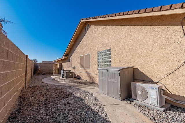 rear view of house featuring ac unit and central air condition unit