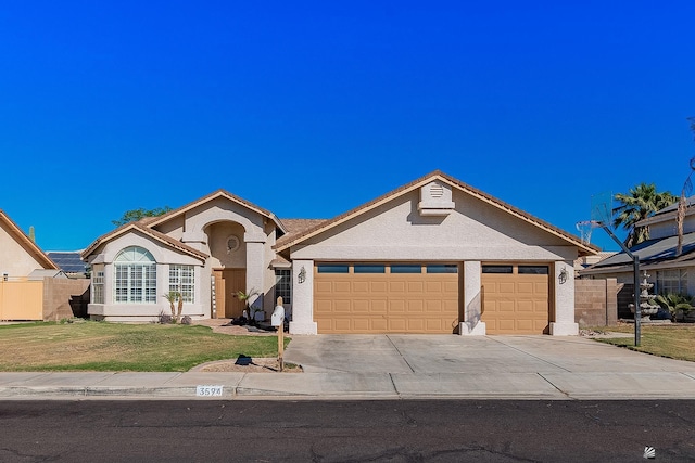 single story home with a garage and a front lawn