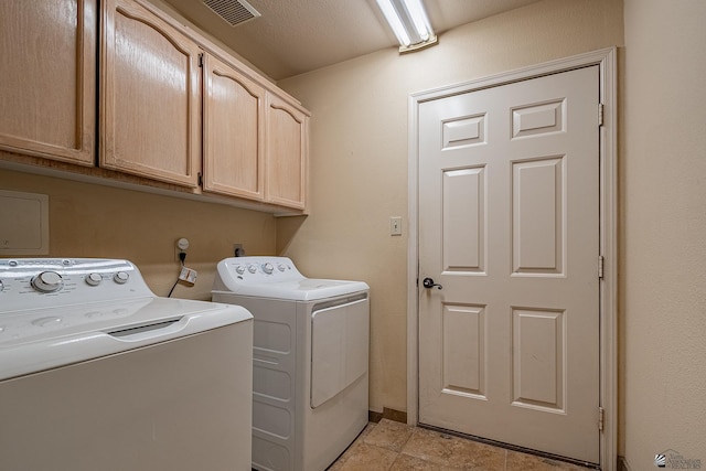 washroom with separate washer and dryer and cabinets