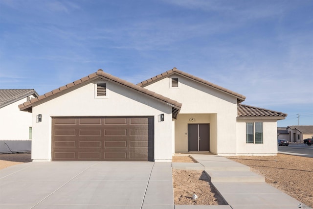 10762 E 45th Pl, Yuma, AZ 85367 - mediterranean / spanish house featuring a garage, stucco siding, concrete driveway, and a tile roof