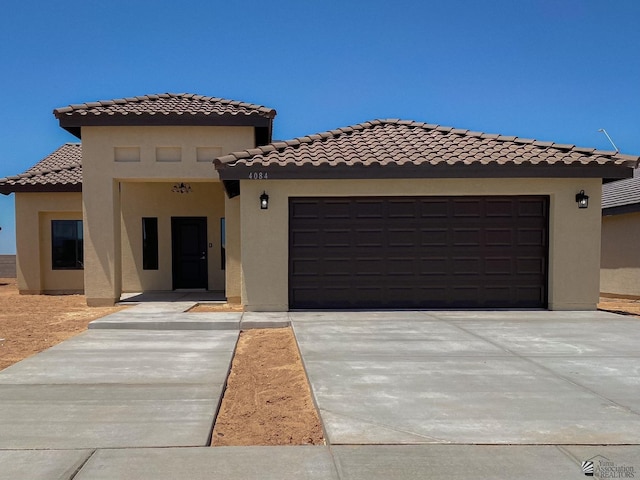 10865 E 45th Ln, Yuma, AZ 85367 - mediterranean / spanish home with an attached garage, stucco siding, and driveway