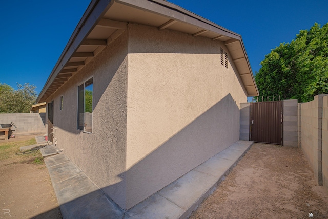 3168 W 31st Ln, Yuma, AZ 85364 - view of property exterior with stucco siding and a gate
