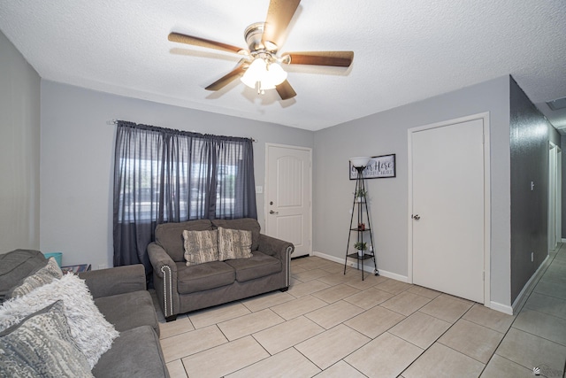 3168 W 31st Ln, Yuma, AZ 85364 - living room featuring ceiling fan, a textured ceiling, light tile patterned floors, and baseboards