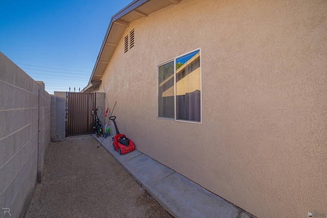 3168 W 31st Ln, Yuma, AZ 85364 - view of property exterior with stucco siding and a gate