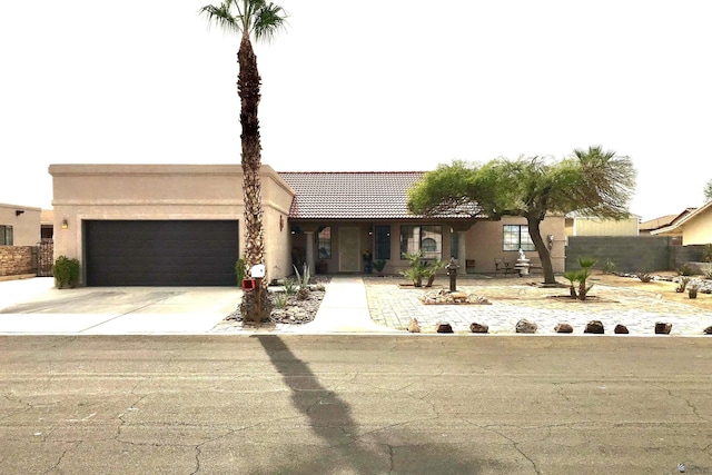 11551 E Via Salida, Yuma, AZ 85367 - view of front of property with concrete driveway, a tiled roof, an attached garage, and stucco siding