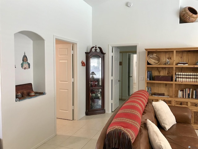 11551 E Via Salida, Yuma, AZ 85367 - living room featuring baseboards, arched walkways, a towering ceiling, and light tile patterned floors