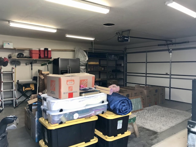 11551 E Via Salida, Yuma, AZ 85367 - garage featuring a garage door opener and stainless steel fridge with ice dispenser