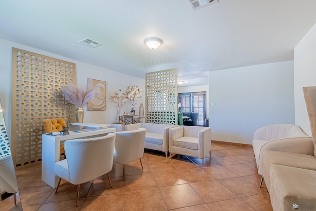 living area featuring visible vents and light tile patterned floors