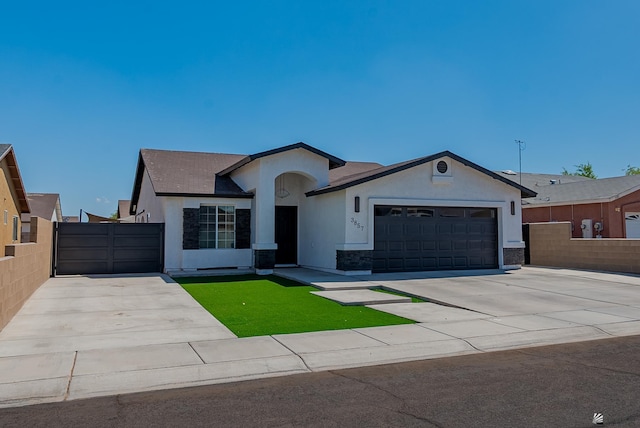 ranch-style home featuring a garage, fence, stucco siding, and stone siding