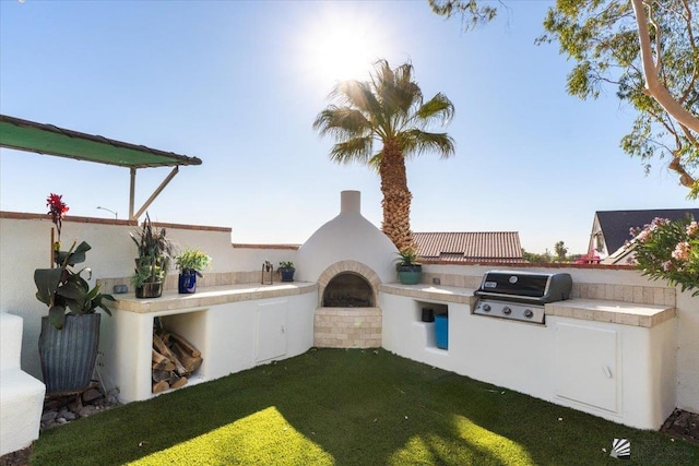 1925 S Ridgeview Dr, Yuma, AZ 85364 - exterior space featuring exterior kitchen and an outdoor brick fireplace