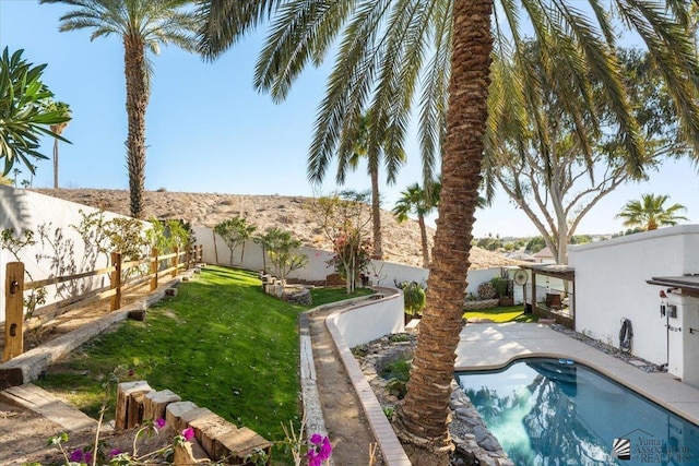 1925 S Ridgeview Dr, Yuma, AZ 85364 - view of swimming pool with a fenced in pool, a fenced backyard, and a yard