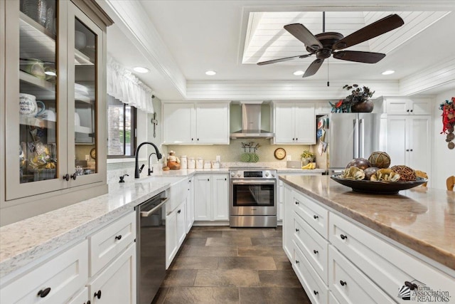 1925 S Ridgeview Dr, Yuma, AZ 85364 - kitchen featuring stone finish flooring, a sink, glass insert cabinets, stainless steel appliances, and wall chimney exhaust hood