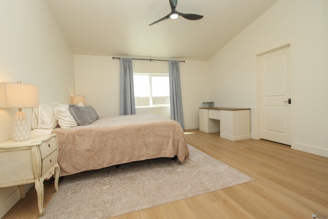 bedroom with a ceiling fan, baseboards, vaulted ceiling, and light wood finished floors