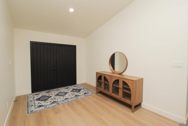 foyer featuring light wood-type flooring, recessed lighting, and baseboards