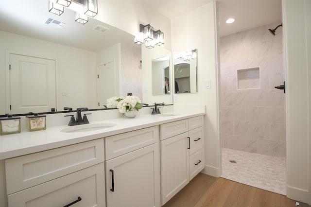 full bath with visible vents, a sink, and walk in shower