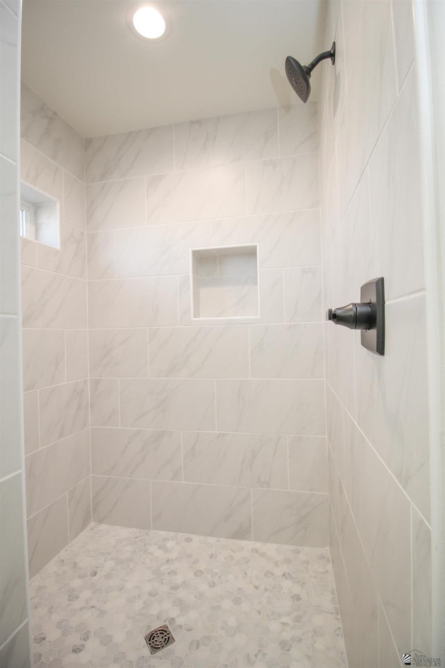 bathroom with a tile shower