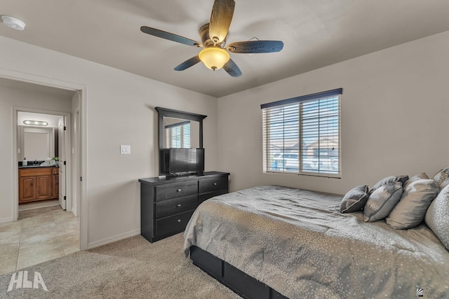 bedroom featuring baseboards, a ceiling fan, light tile patterned flooring, and light colored carpet