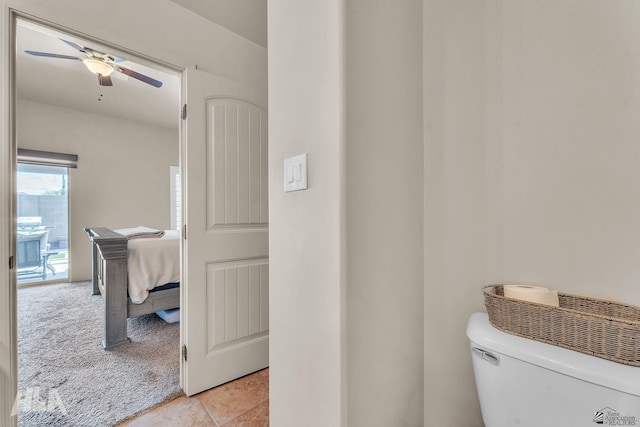 bathroom featuring toilet, ceiling fan, and tile patterned flooring