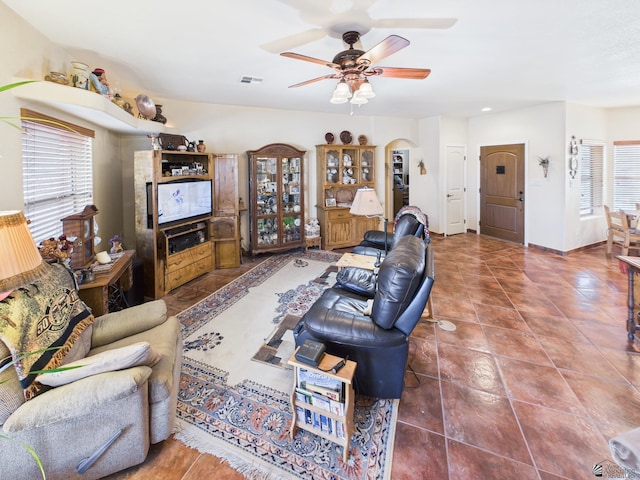14340 E 49th Ln, Yuma, AZ 85367 - living area featuring visible vents, tile patterned flooring, baseboards, arched walkways, and a ceiling fan