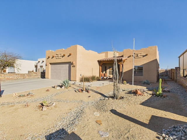 14340 E 49th Ln, Yuma, AZ 85367 - pueblo-style house featuring fence, a garage, stucco siding, a tiled roof, and driveway
