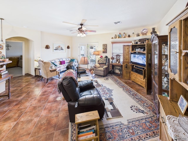 14340 E 49th Ln, Yuma, AZ 85367 - living room with visible vents, arched walkways, ceiling fan, and tile patterned flooring