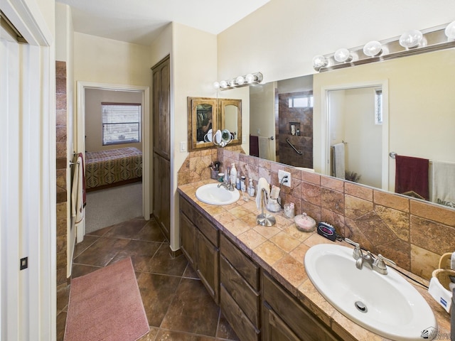 14340 E 49th Ln, Yuma, AZ 85367 - ensuite bathroom with a sink, tile patterned floors, double vanity, and connected bathroom