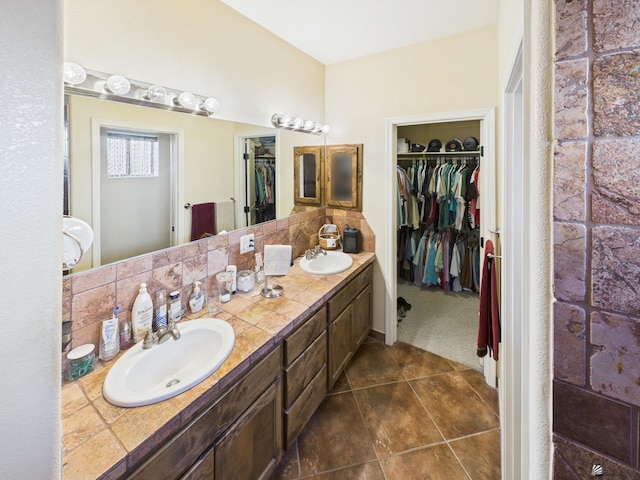 14340 E 49th Ln, Yuma, AZ 85367 - full bathroom featuring double vanity, a sink, a walk in closet, and tile patterned floors