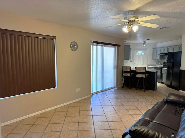 13458 E 53rd Ln, Yuma, AZ 85367 - living area featuring light tile patterned floors, visible vents, ceiling fan, and a textured ceiling