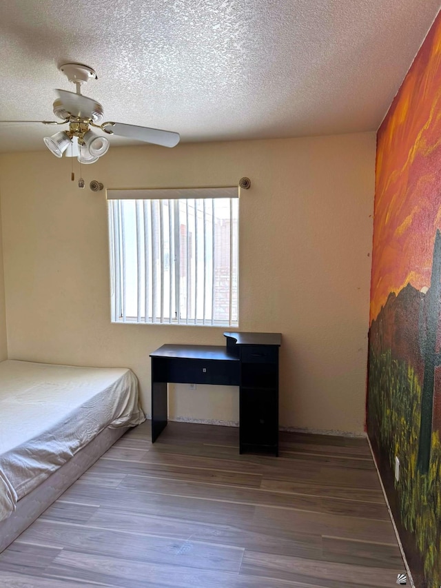 13458 E 53rd Ln, Yuma, AZ 85367 - bedroom featuring ceiling fan, a textured ceiling, and wood finished floors