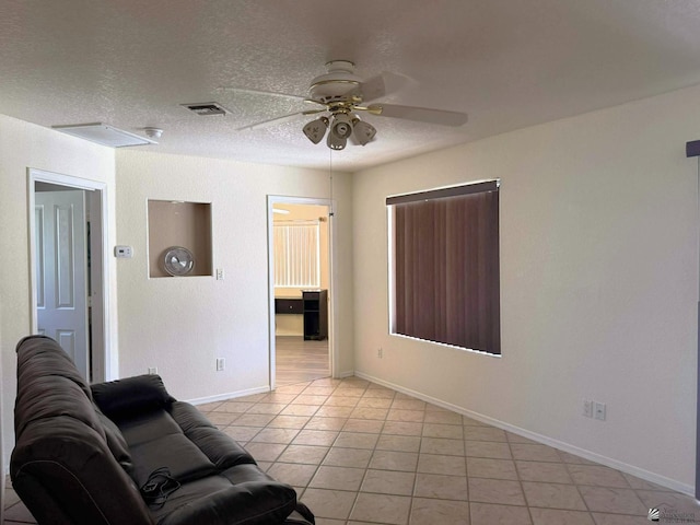 13458 E 53rd Ln, Yuma, AZ 85367 - living room with light tile patterned floors, ceiling fan, and a textured ceiling