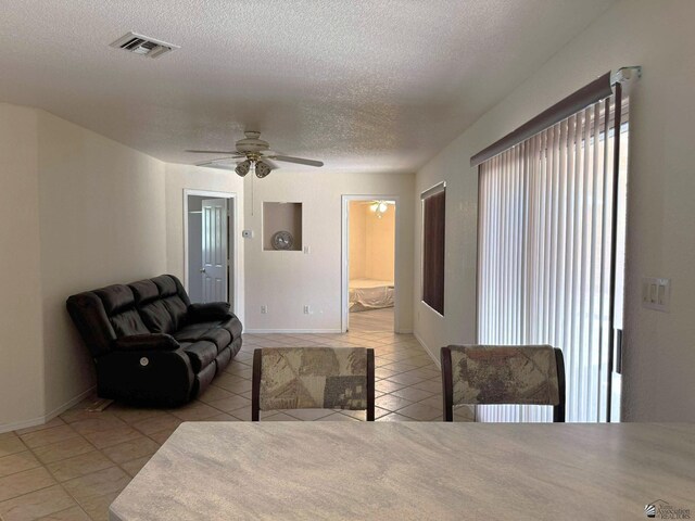 13458 E 53rd Ln, Yuma, AZ 85367 - living area with tile patterned floors, a textured ceiling, and a ceiling fan