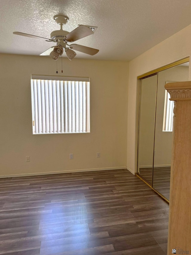 13458 E 53rd Ln, Yuma, AZ 85367 - unfurnished bedroom with multiple windows, a closet, a textured ceiling, and wood finished floors