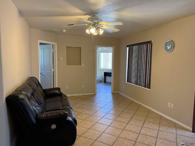 13458 E 53rd Ln, Yuma, AZ 85367 - living area with light tile patterned floors, baseboards, visible vents, and a ceiling fan