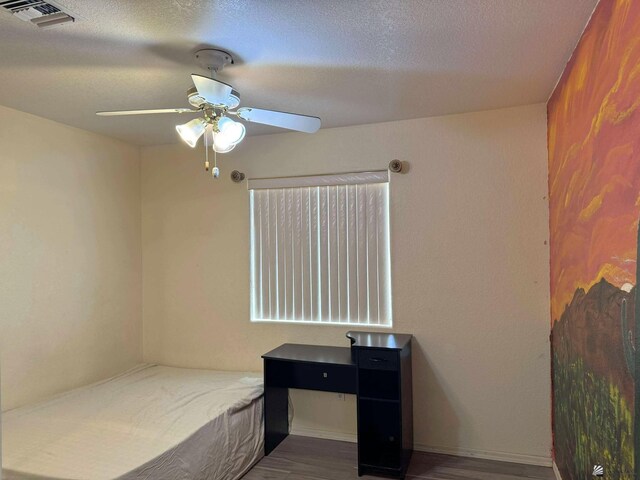 13458 E 53rd Ln, Yuma, AZ 85367 - bedroom featuring wood finished floors, ceiling fan, and a textured ceiling